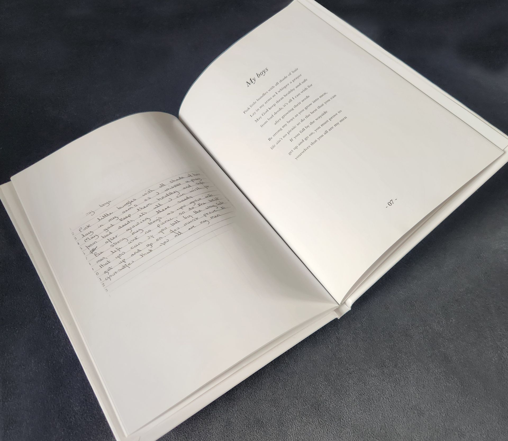 Open book on a dark surface, with visible text on both cream-colored pages.