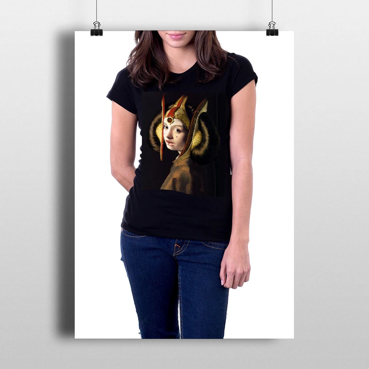 Woman wearing a black T-shirt with a goddess portrait and blue jeans, standing against a white background