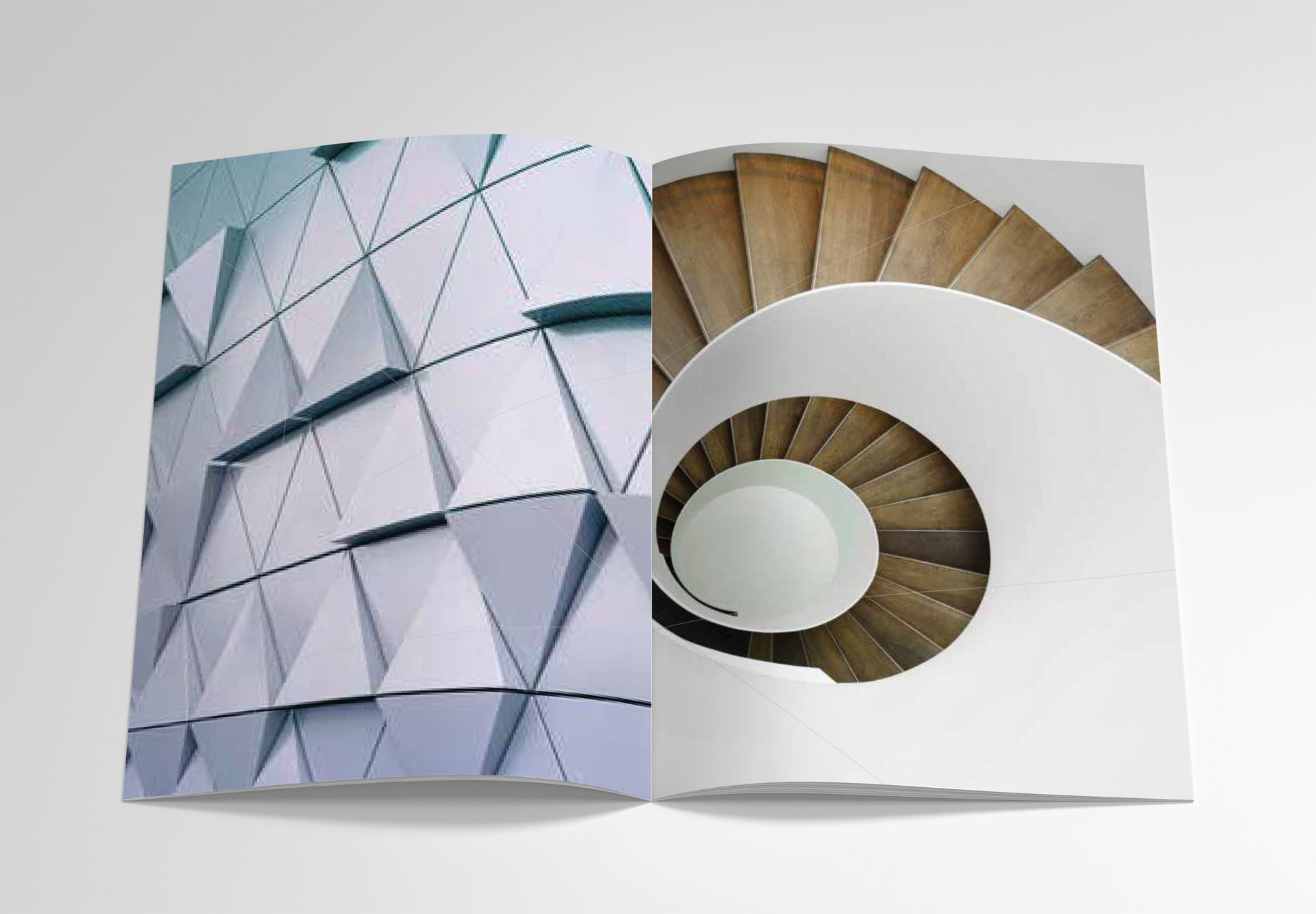Abstract architectural spiral on a folded booklet with white, tan, and pale blue geometric panels