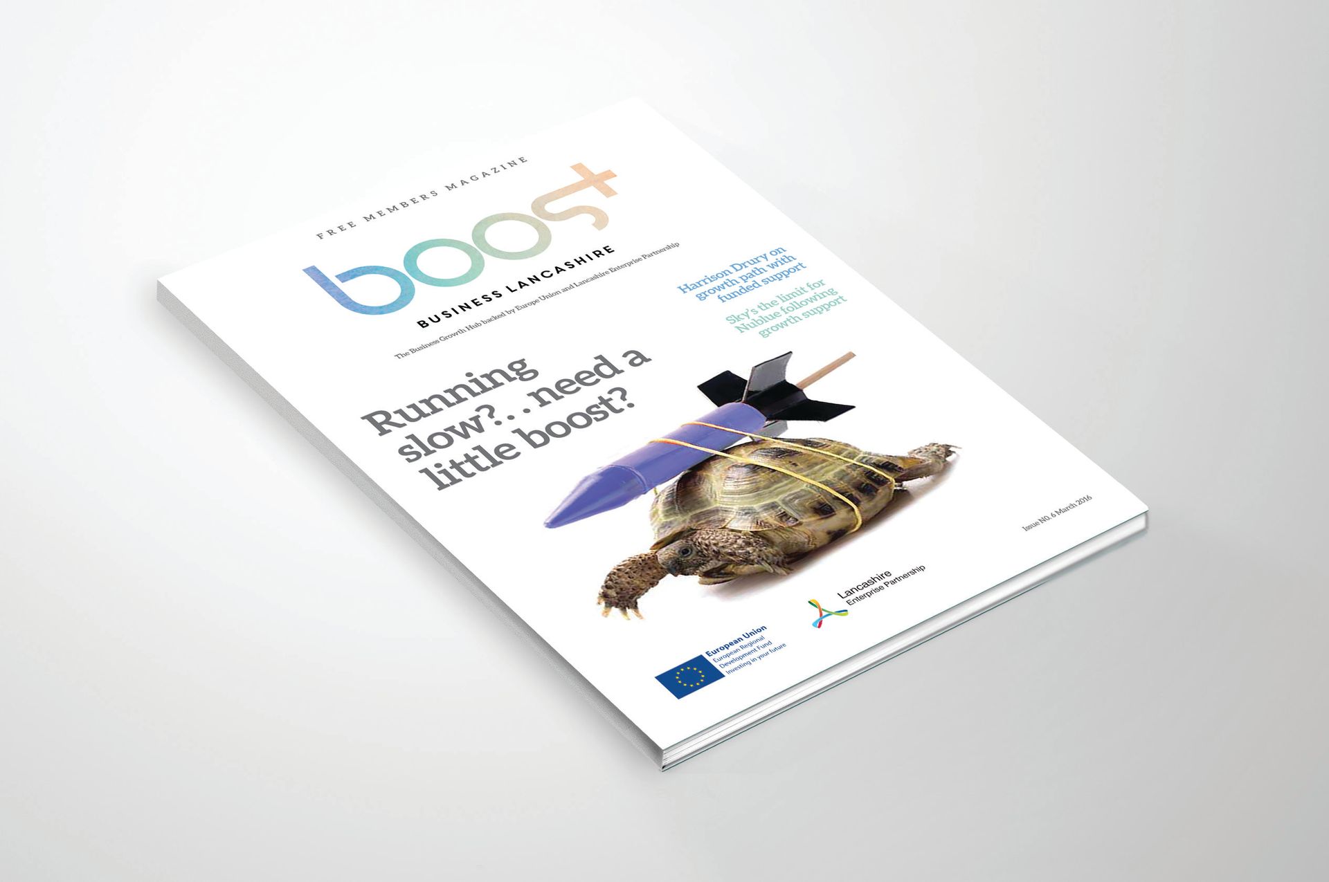 Mock magazine cover titled “boost” with a penguin on a white cover, angled on a light background