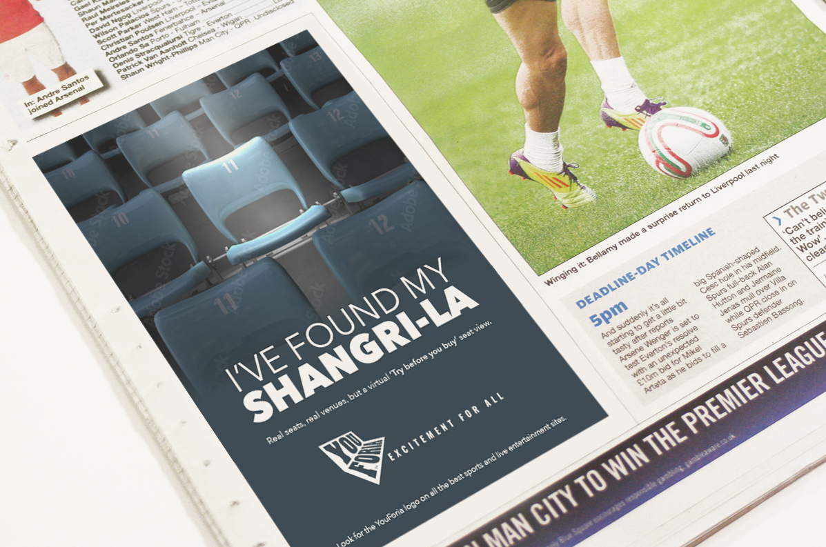 Newspaper spread with a dark ad and a soccer player on a field, featuring the headline “I’ve found my Shangri-La.”