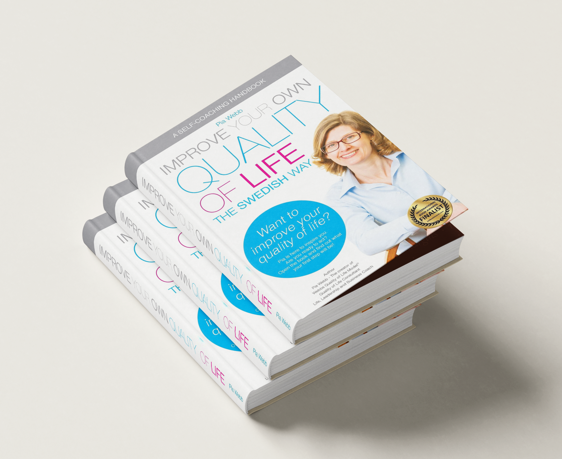 Stack of white magazines with a smiling woman on the cover and pink-blue text
