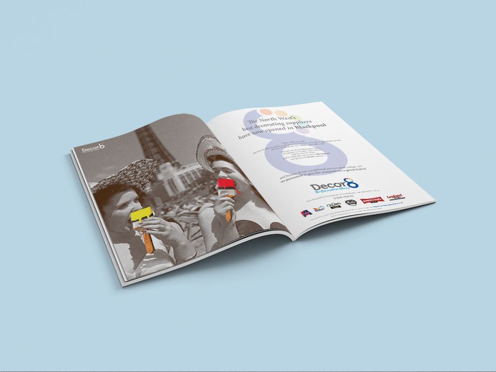 Open booklet with gray and white pages on a light blue background, showing illustrated figures and charts