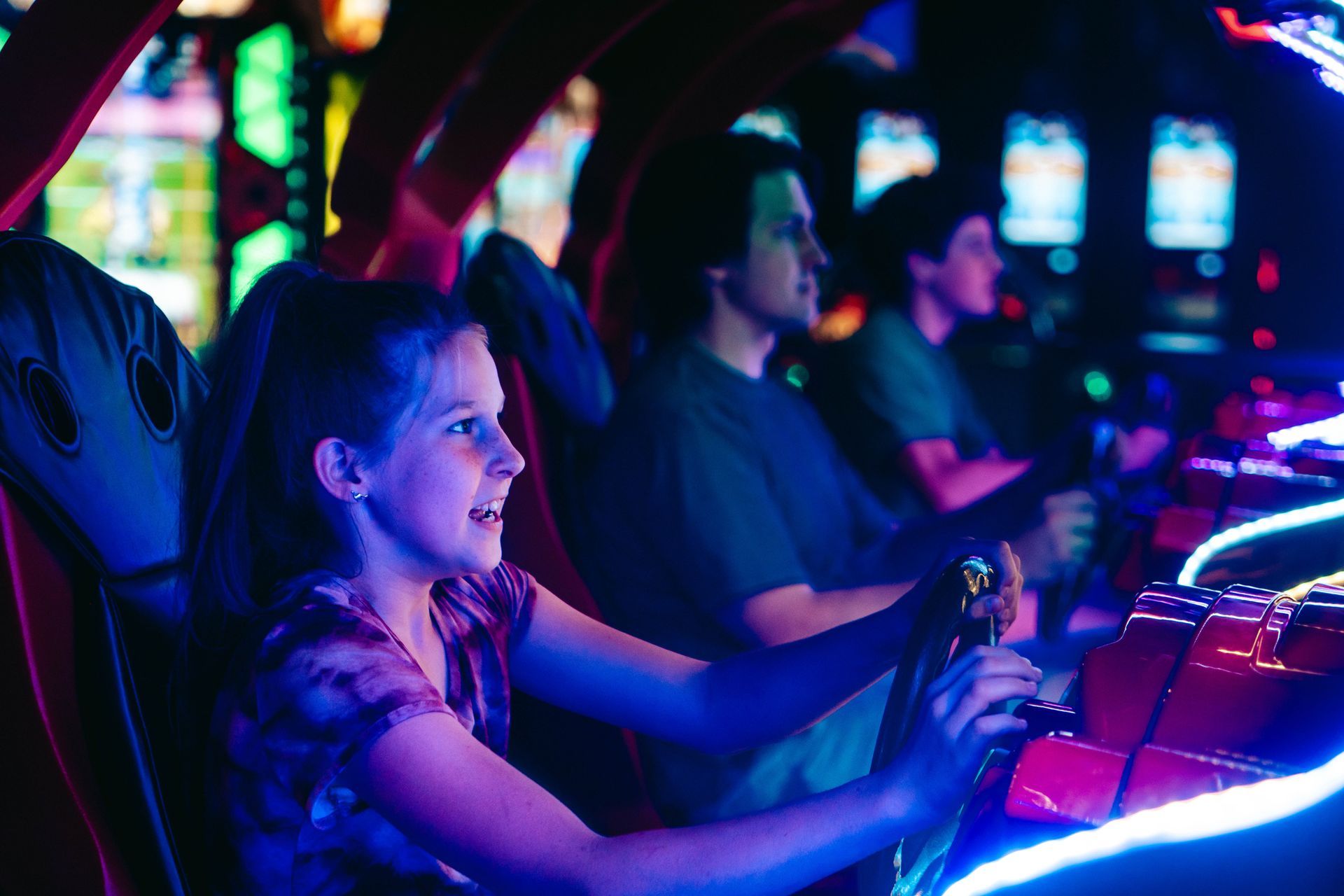 Playing in an arcade with neon lights.