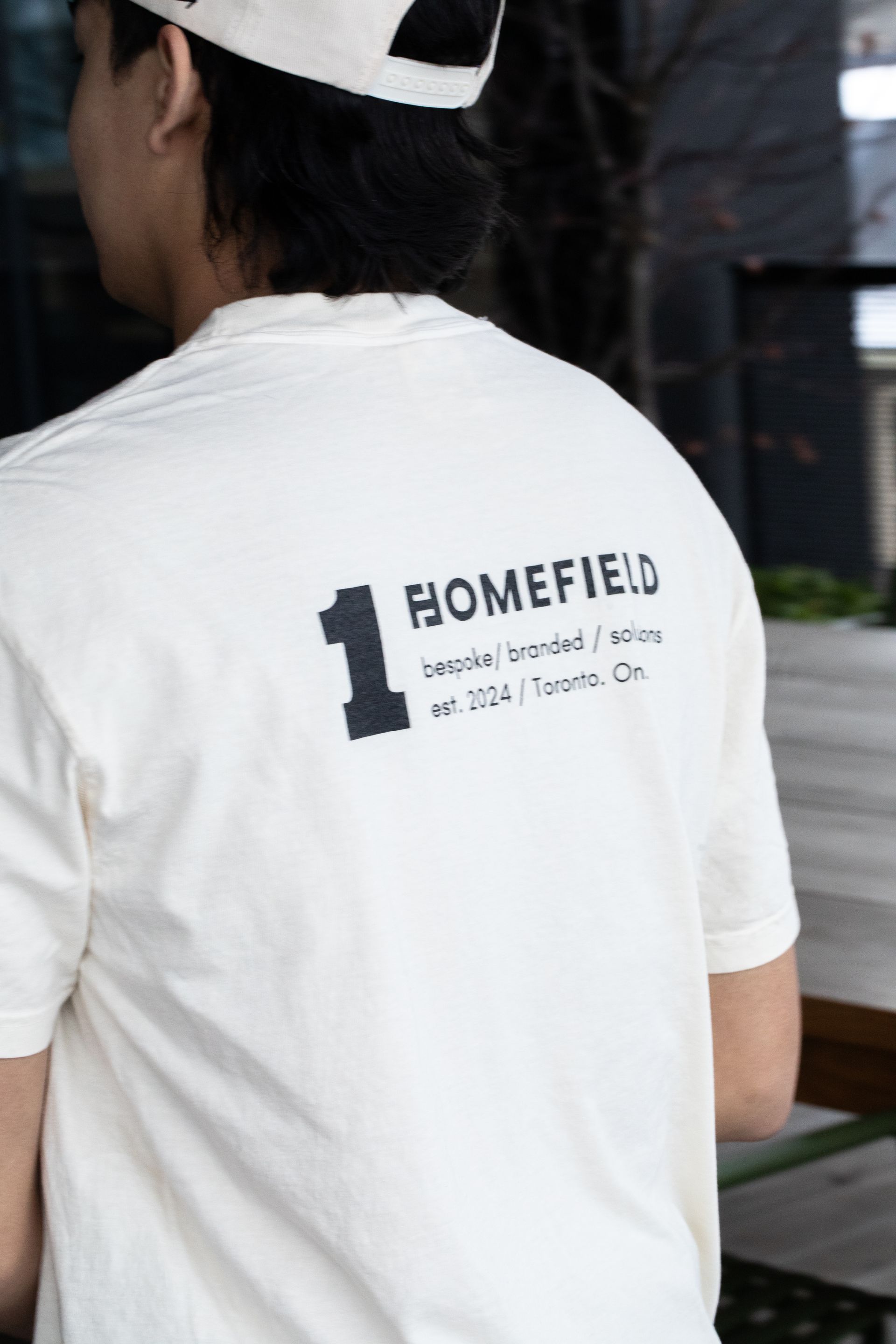 A man wearing a white t-shirt with the number 1 on it.