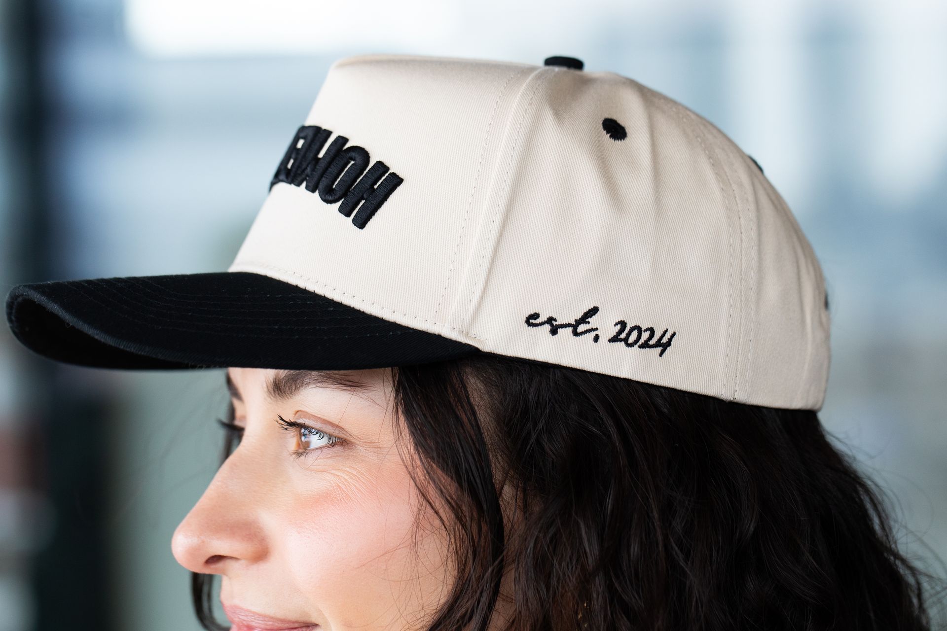 A close up of a woman wearing a baseball cap