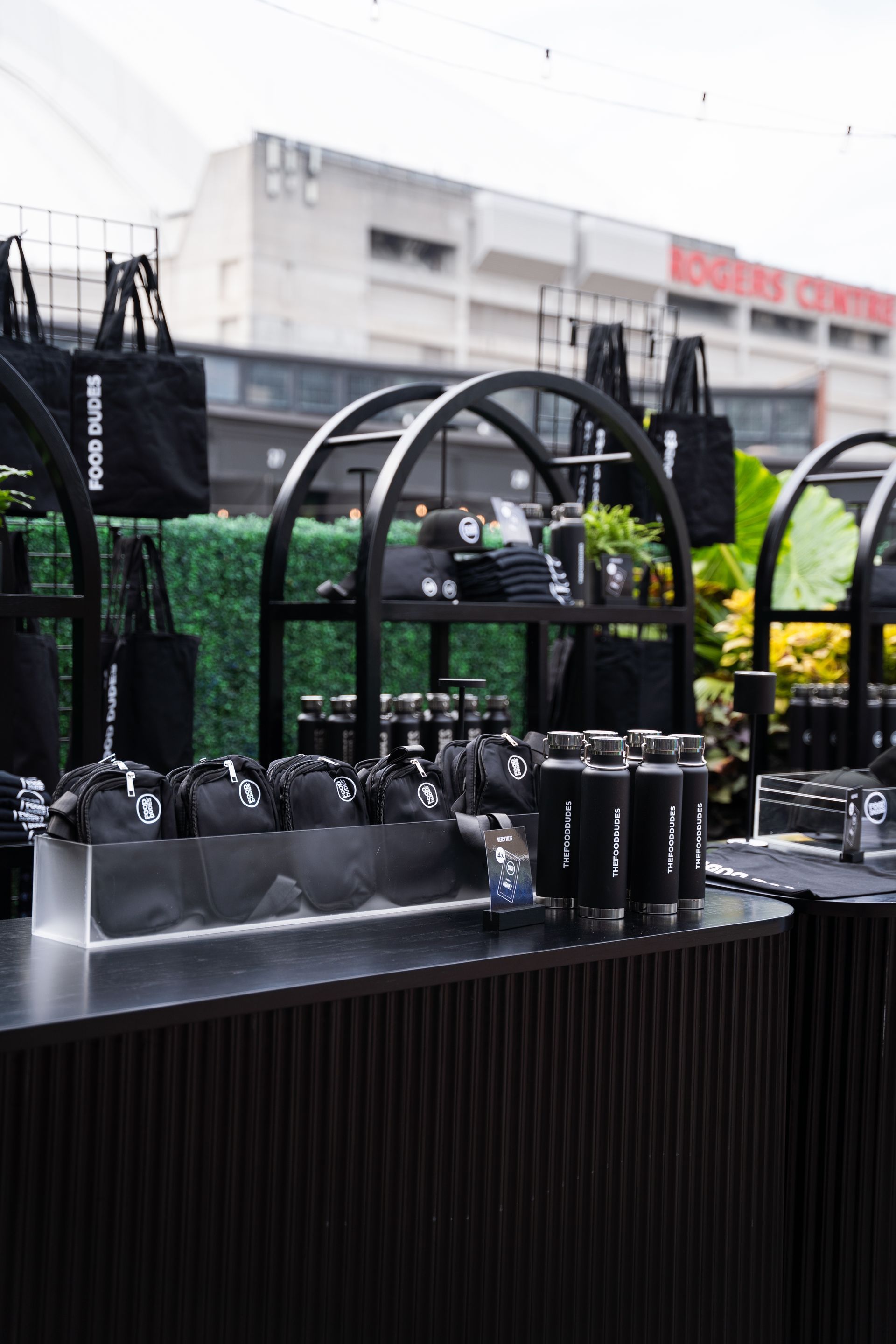 An elegant merch table with the Rogers Centre in the background