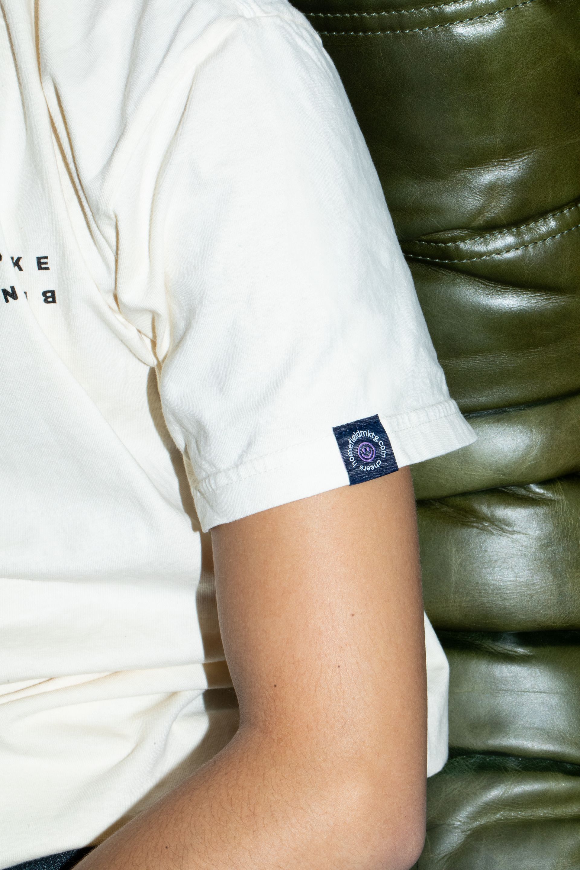 A close up of a person 's arm wearing a white t-shirt