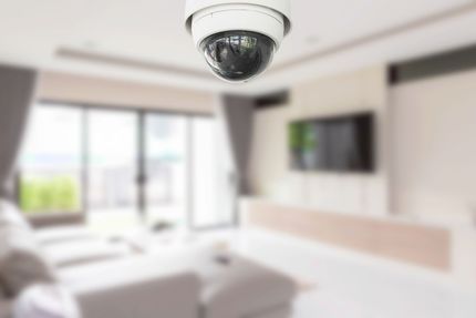 Ceiling security camera in a bright, modern living room Ceiling security camera in a bright, modern living room