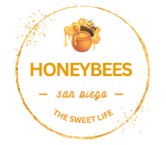 Gold-colored stylized bee with open wings, cut-out design on a white background.