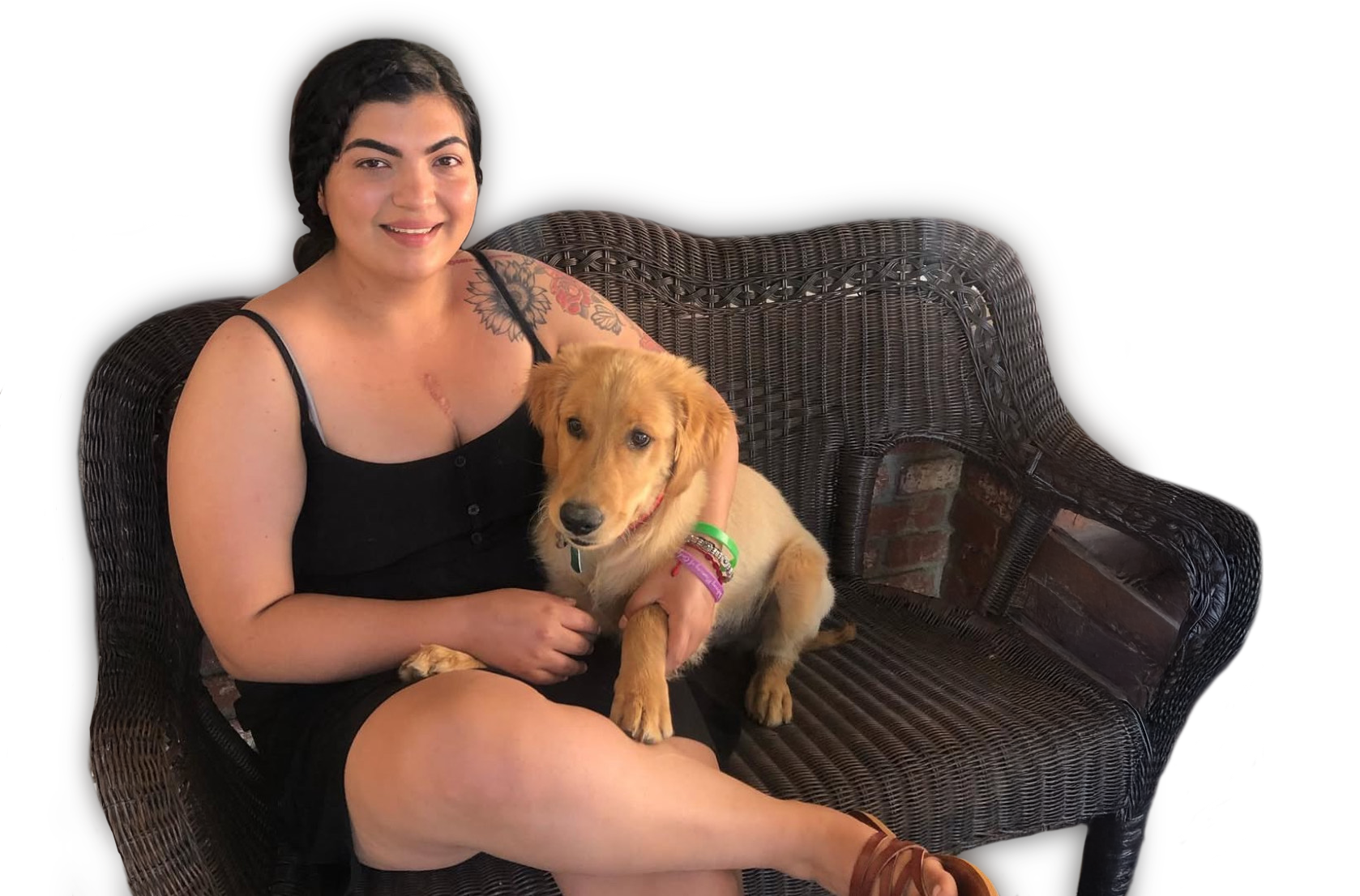 A woman is sitting on a couch holding a dog.