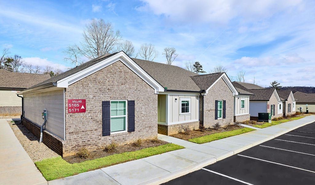 A row of houses are lined up next to each other in a residential area.