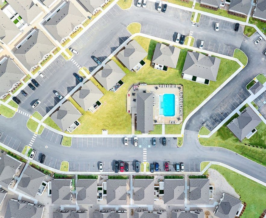 An aerial view of a residential area with a swimming pool