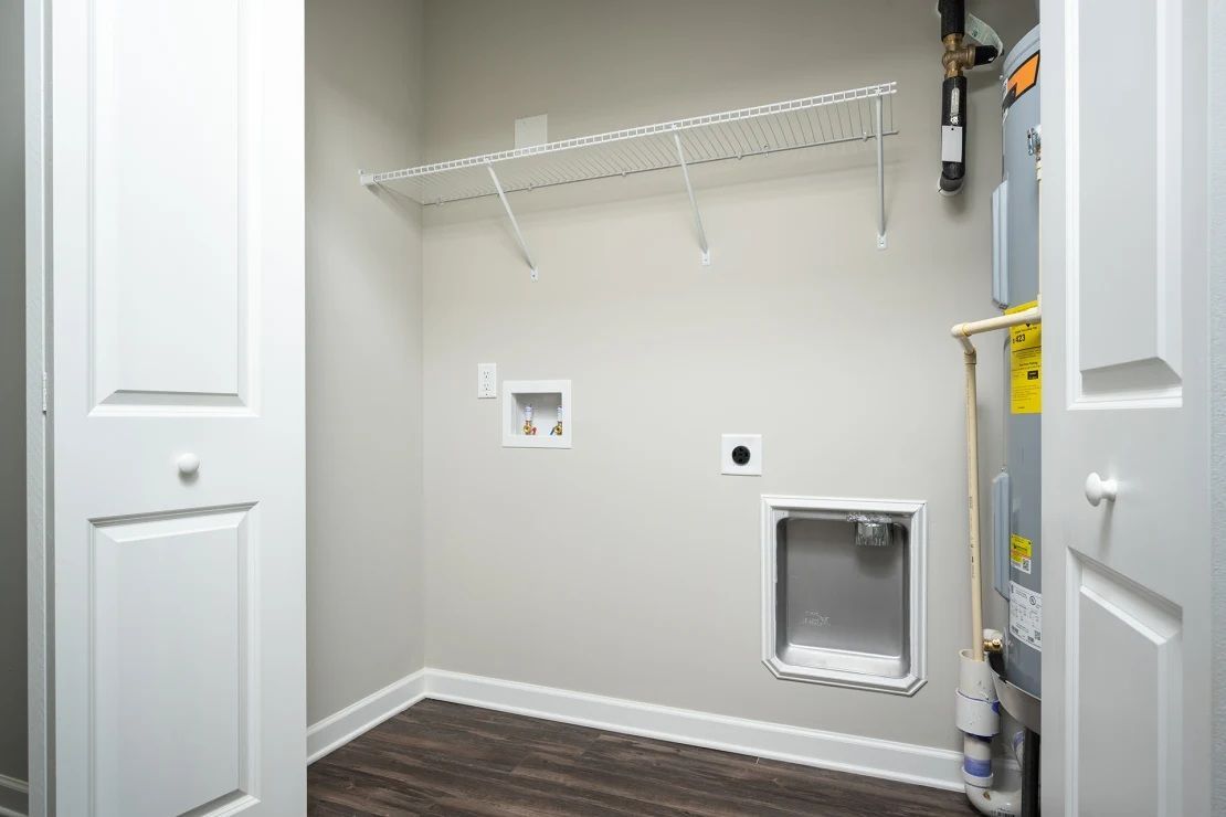 A laundry room with a washer and dryer in a house.