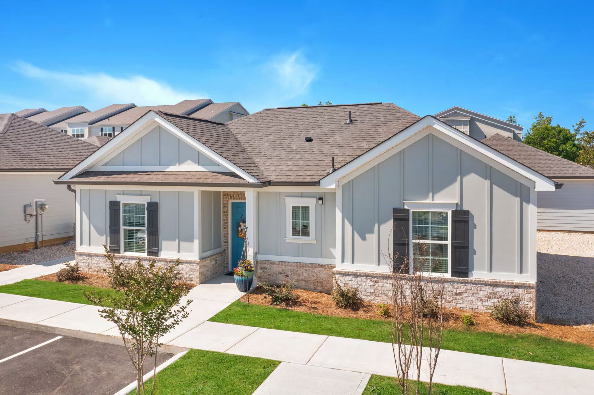 An aerial view of a house with a blue door and shutters.