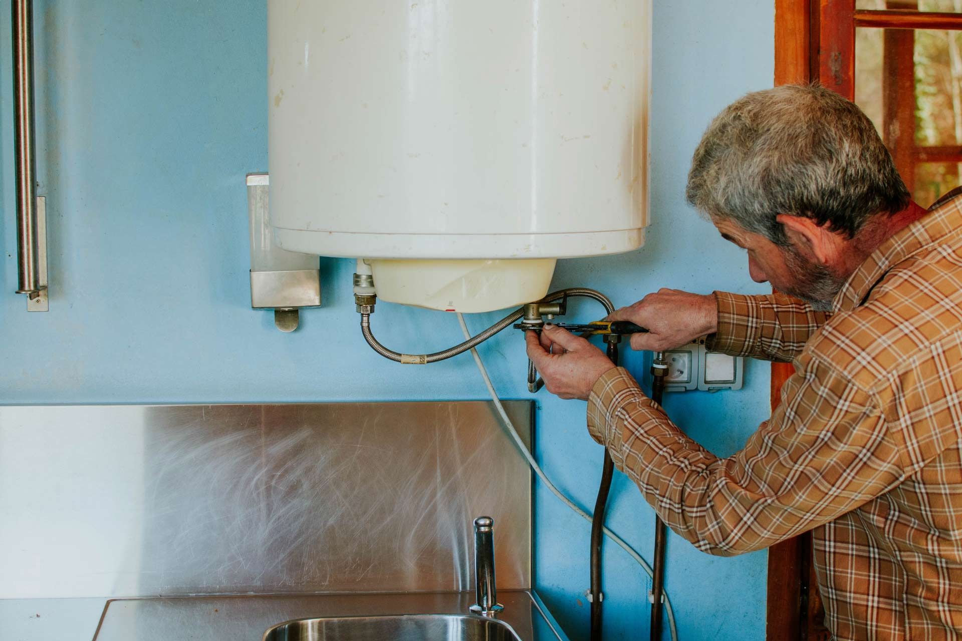 Man repairing water heater
