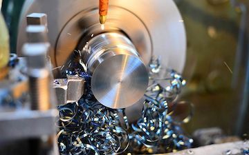 A machine is cutting a piece of metal on a lathe — Line Boring in Chevallum, QLD