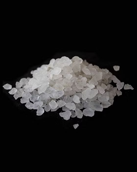 Pile of translucent white crystals on a black background