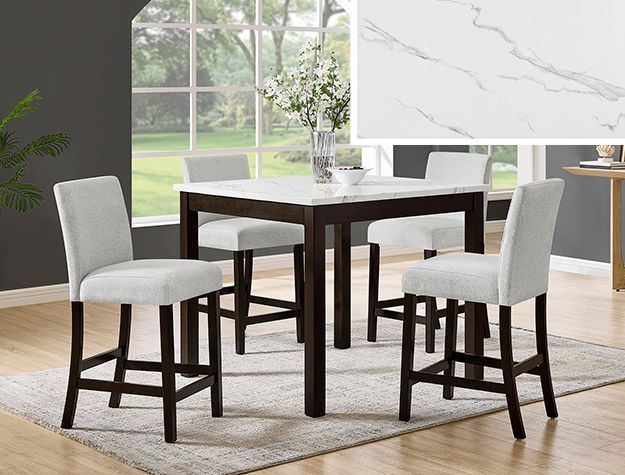 Modern dining table with four gray upholstered chairs in a bright room