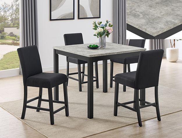 Modern black dining table with four black chairs in a bright room, vase centerpiece on top