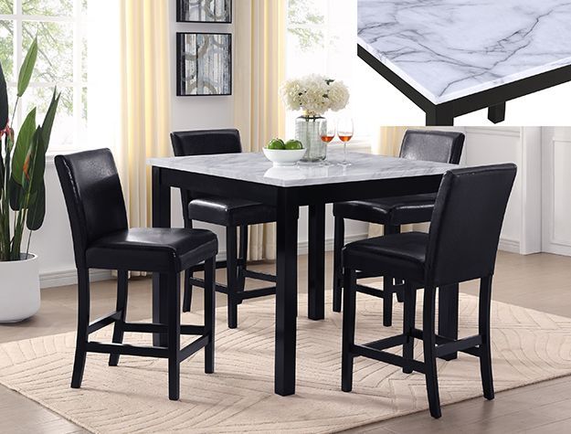 Black dining table with four chairs in a bright modern room