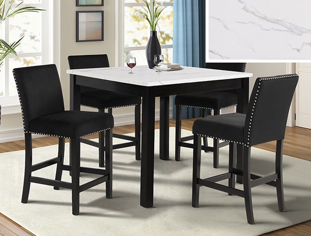 Black dining table with four matching chairs in a bright modern room