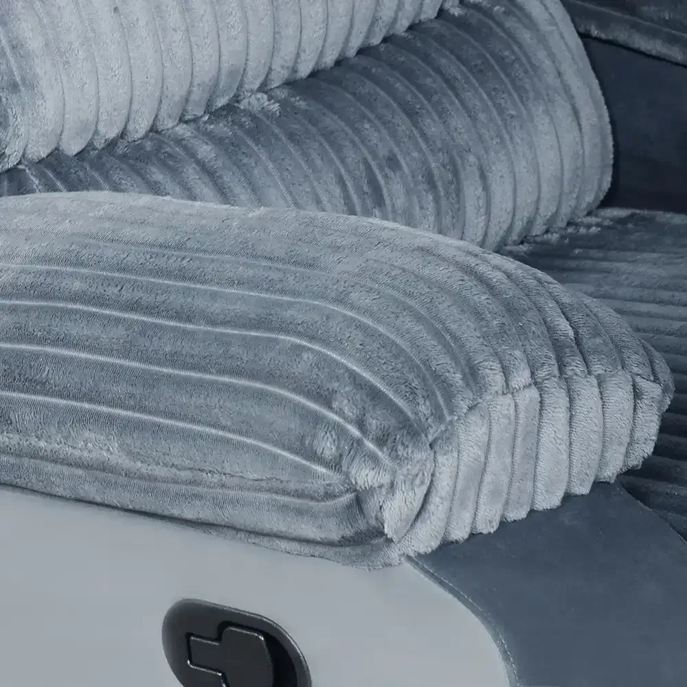Gray folded towels stacked on a white cabinet with a black knob