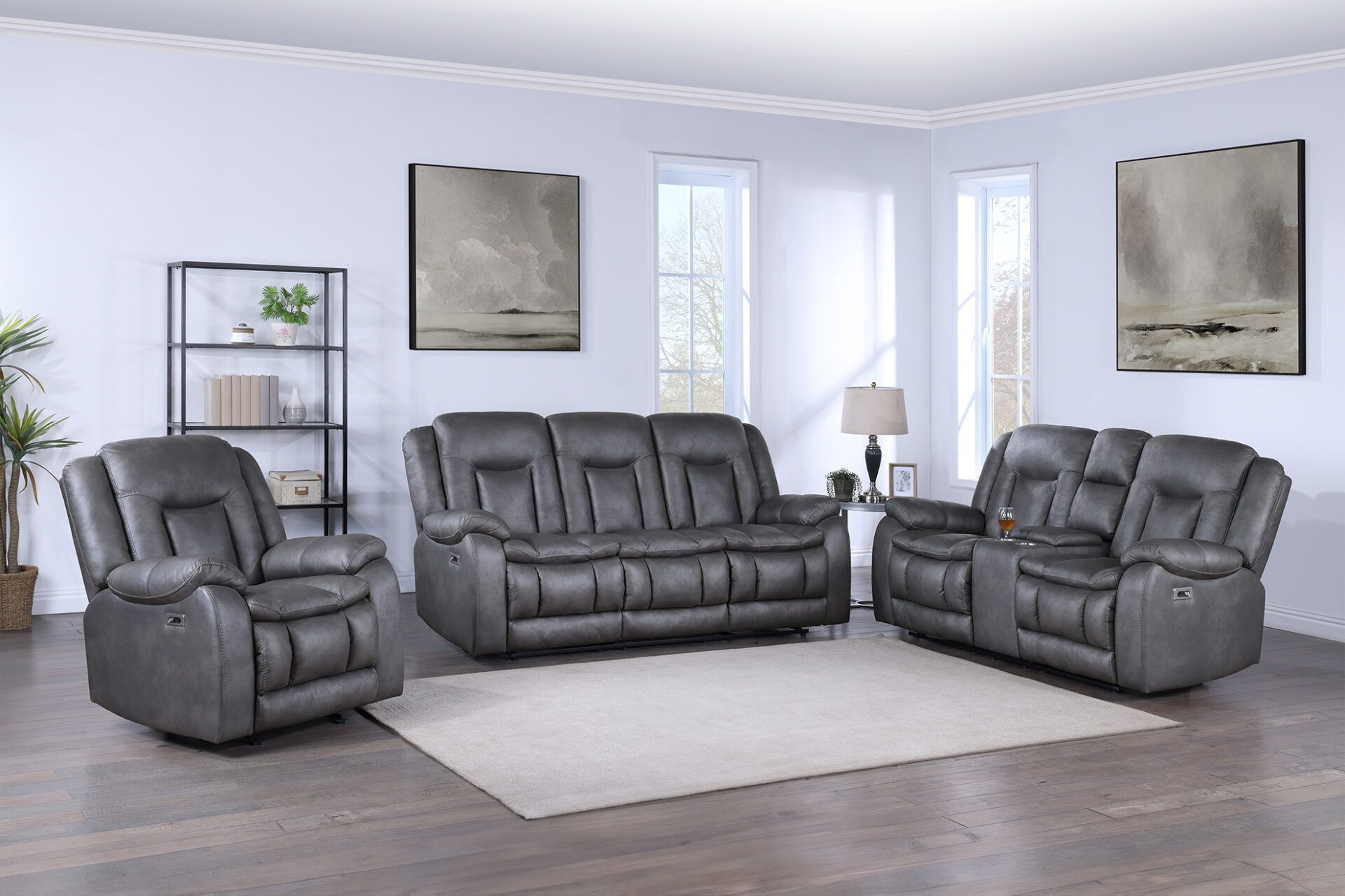 Gray leather living room set with sofa, loveseat, recliner, lamp, rug, and wall art in a bright room