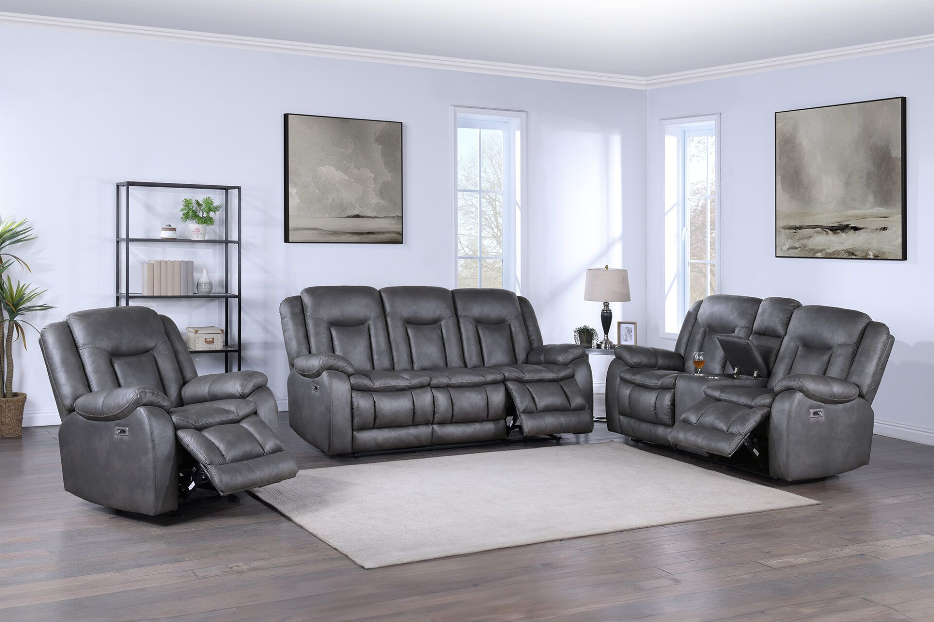 Gray leather living room sofa set with recliner chairs on a light rug in a bright, modern room