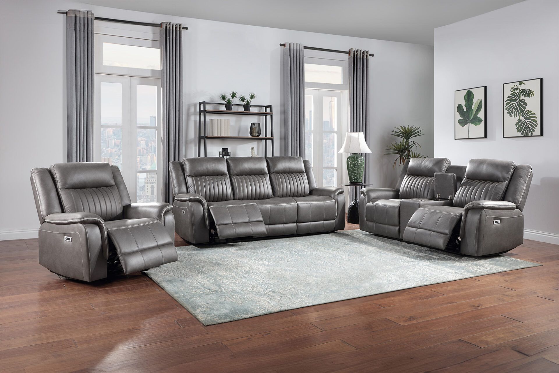Modern living room with gray leather reclining sofas, chaise chair, and light rug on hardwood floors.