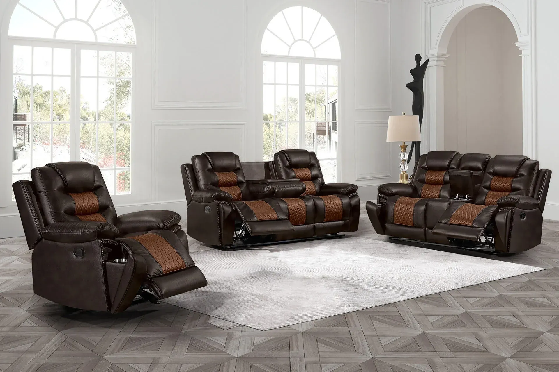 Dark brown leather reclining sofa set in a bright white living room with arched windows