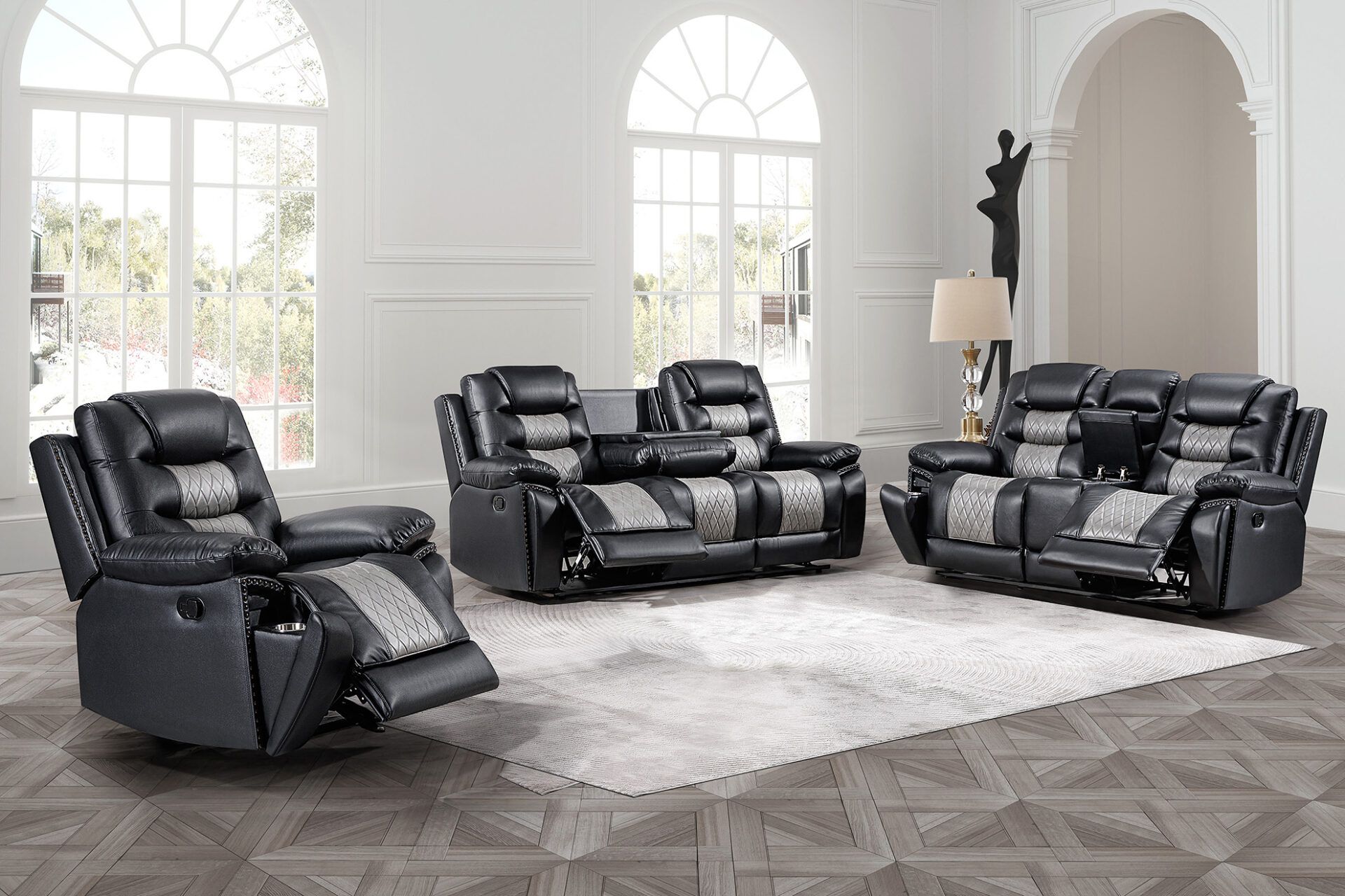 Black leather reclining sofa set arranged in a bright white living room around a rug