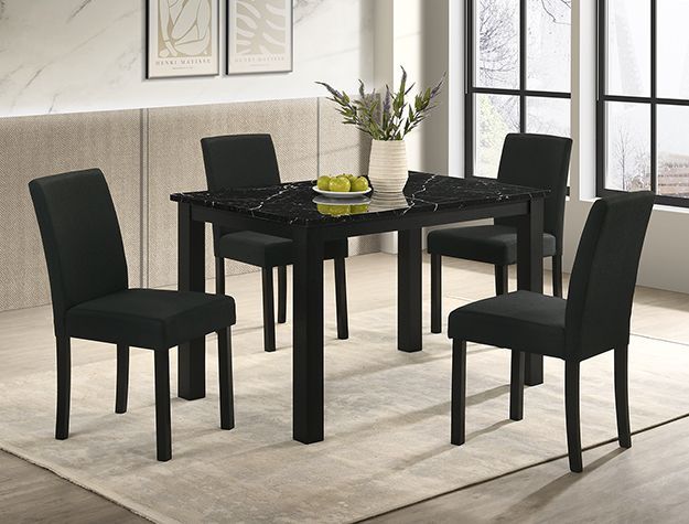 Black dining table with four black chairs in a bright, modern dining room