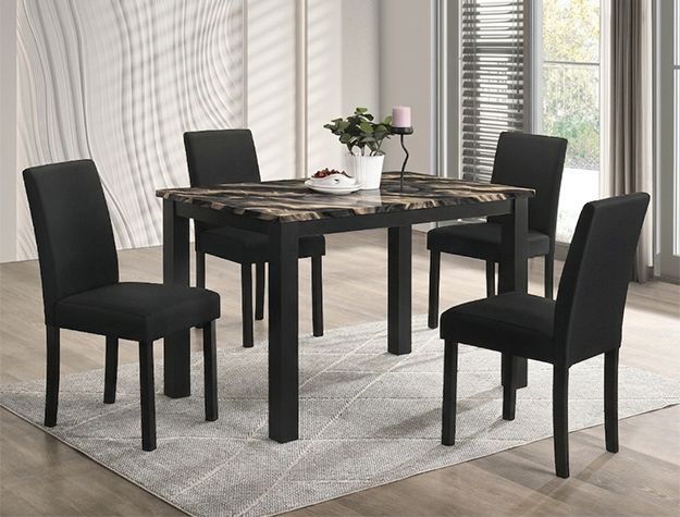 Black dining table with four chairs on a light rug in a bright room, set with a small centerpiece