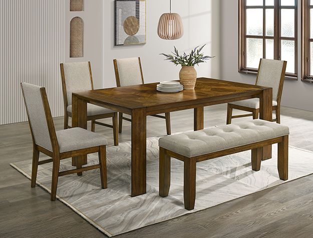 Wooden dining table set with upholstered chairs and bench on a light rug in a bright room