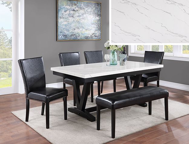 Modern dining room with a black table, four chairs, a bench, and a light rug under a framed painting.