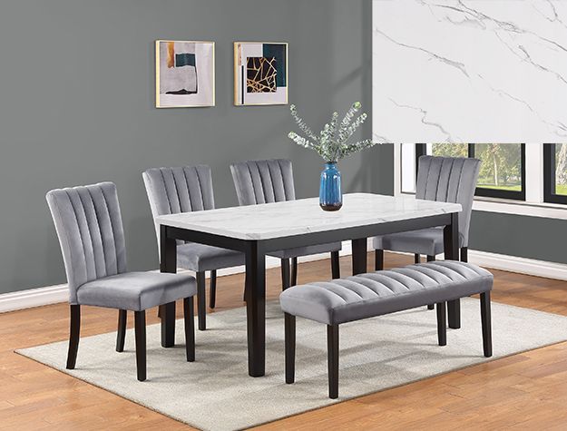 Modern dining room with gray upholstered chairs, a dark table, blue vase, and framed wall art