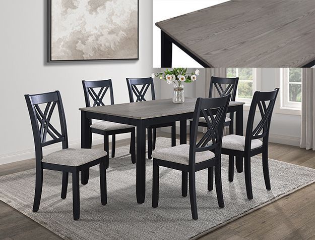 Black dining table with six chairs on a gray rug in a bright modern room