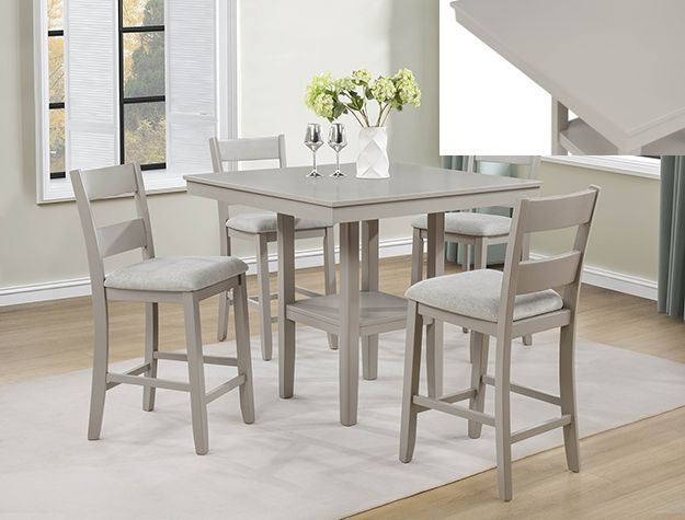 Modern dining table set with four gray chairs in a bright living room