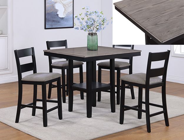 Black dining table set with four chairs on a light rug, vase centerpiece, and wood tabletop inset detail in corner view
