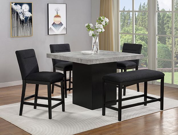 Modern dining room with black chairs, a dark table, and a white rug by a window with flowers.