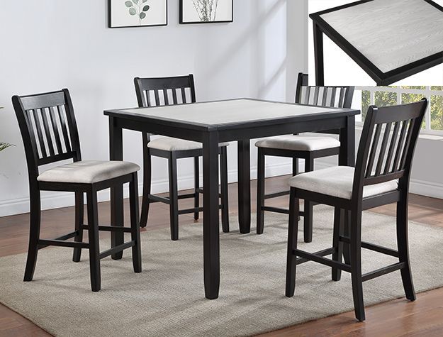 Black dining table with four matching chairs on a light rug in a modern room