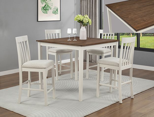 White dining table with chairs on a rug in a bright room near a window