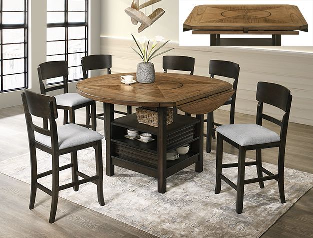 Dark wood round dining table with six black chairs on a light rug in a bright room