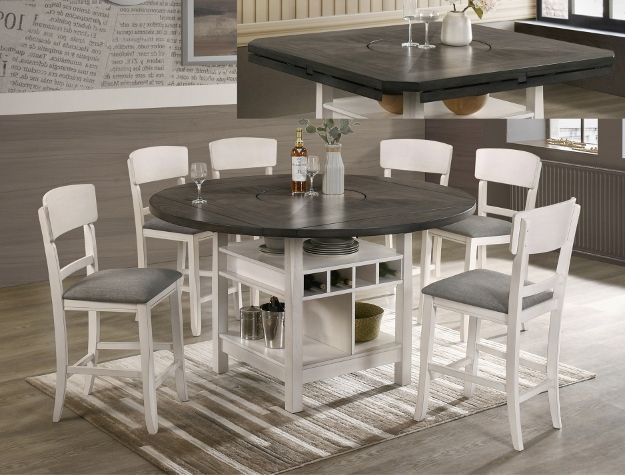 Round dark-wood dining table with white chairs around it in a bright dining room