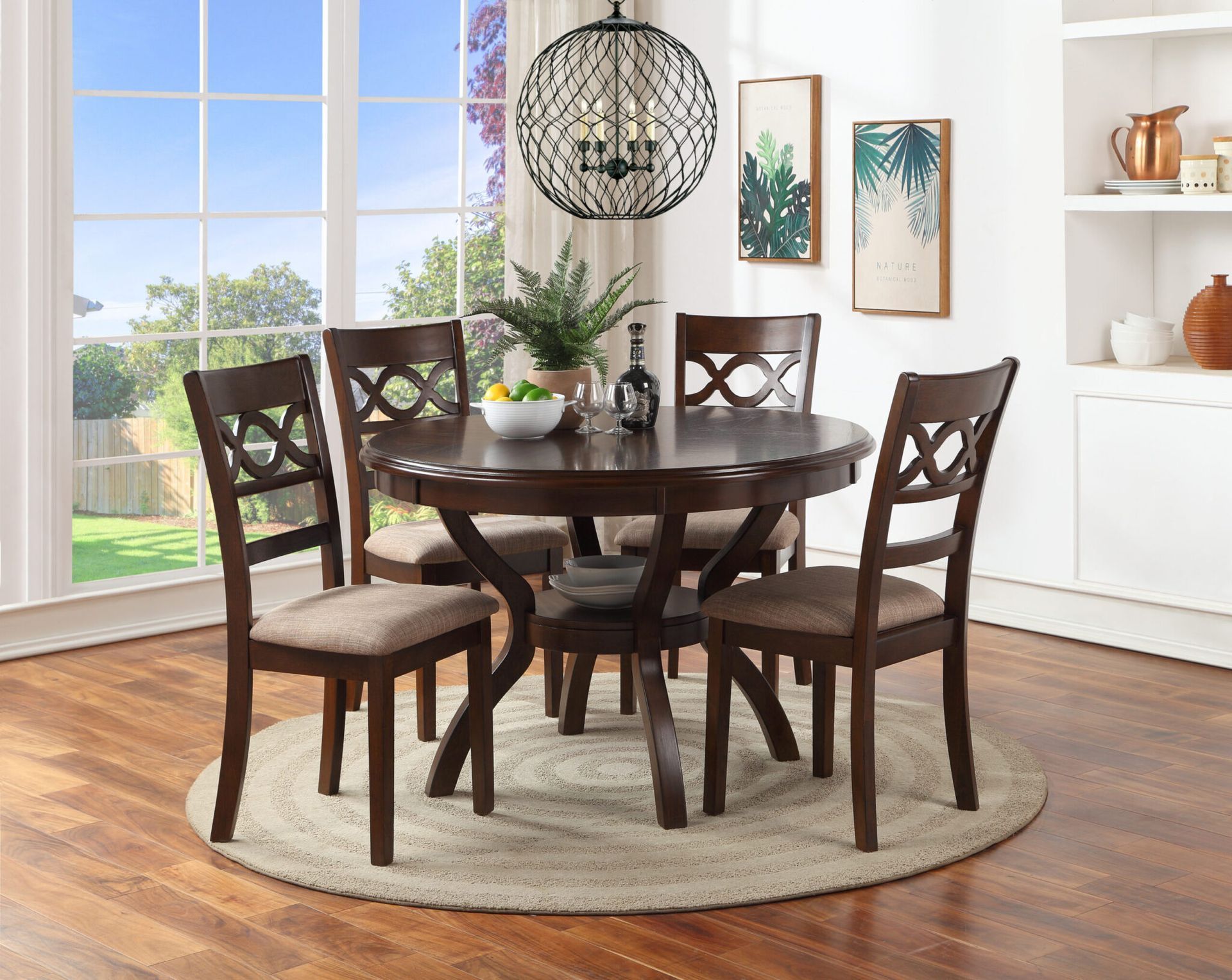 Round dark wood dining set on a light rug in a bright room with a large window and wall decor