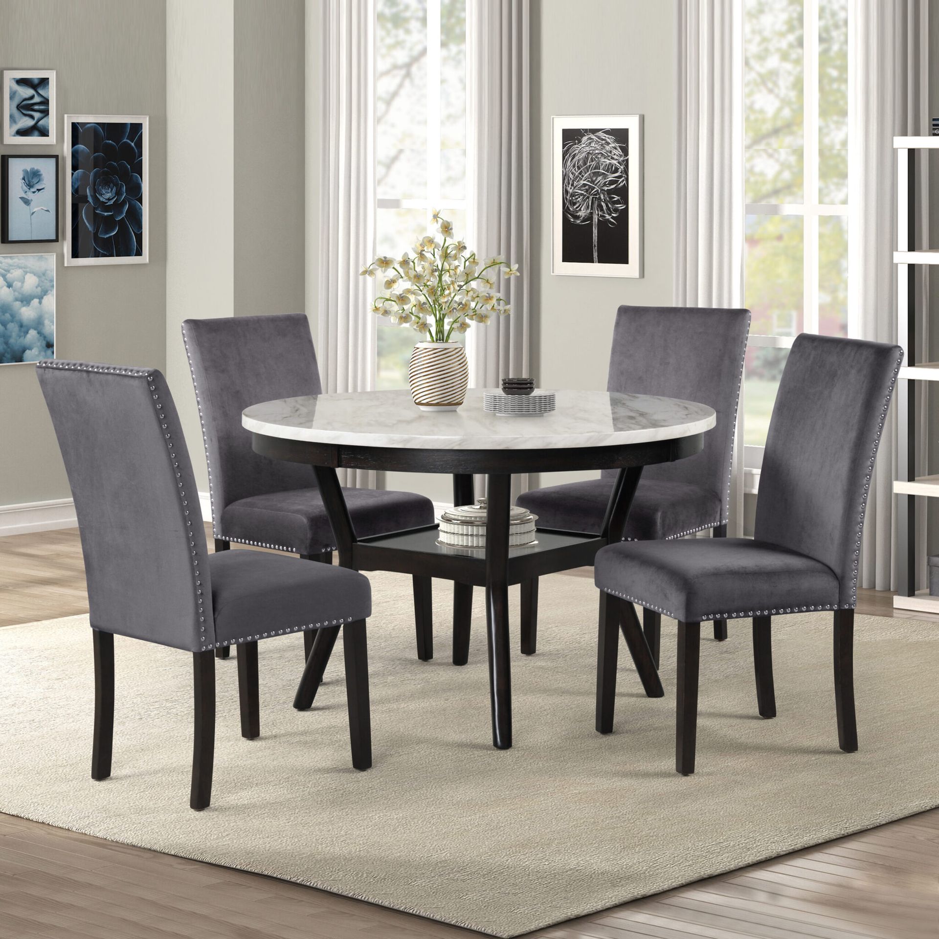 Gray dining set with round table and four upholstered chairs in a bright living room