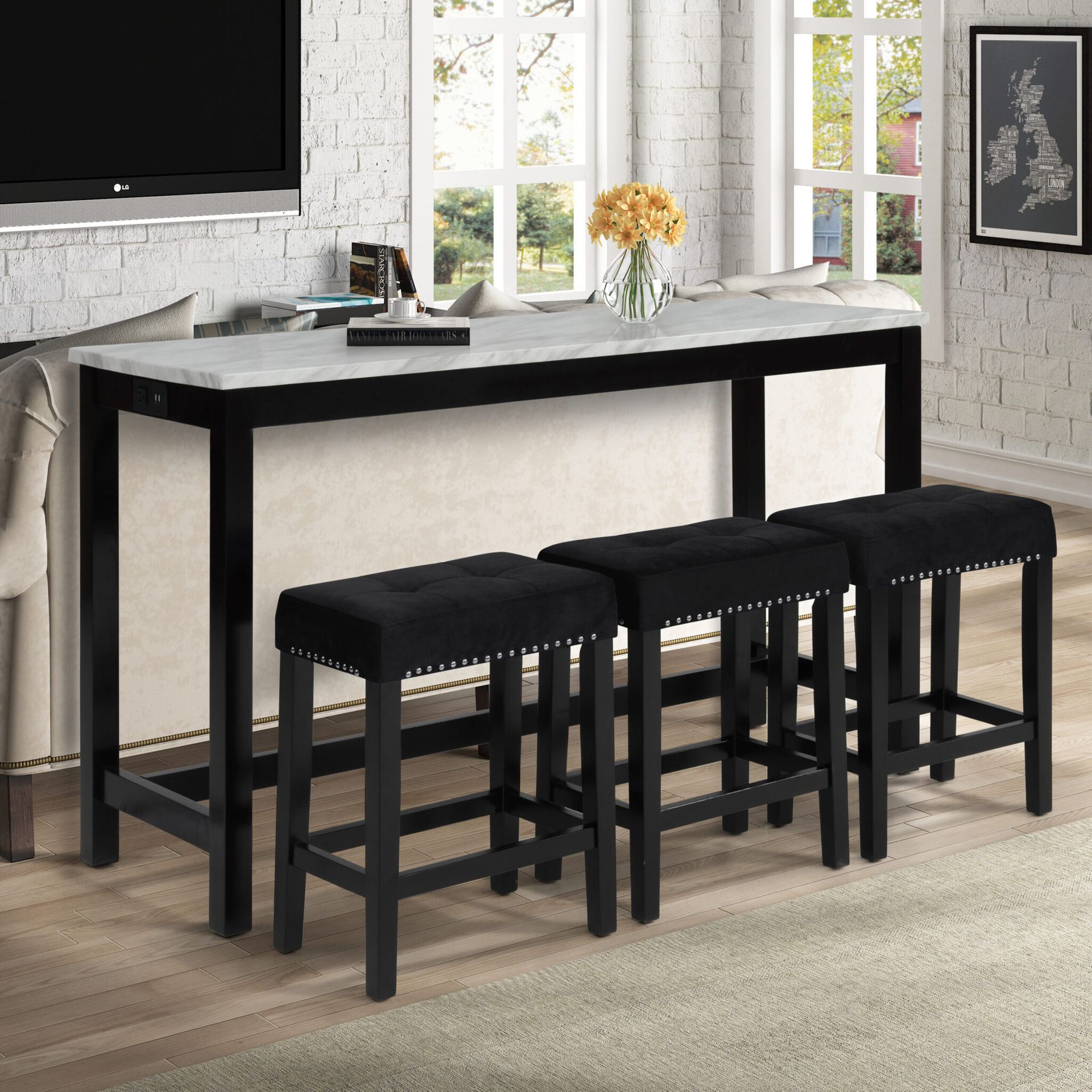 Black counter-height dining table with four stools in a bright kitchen or dining area