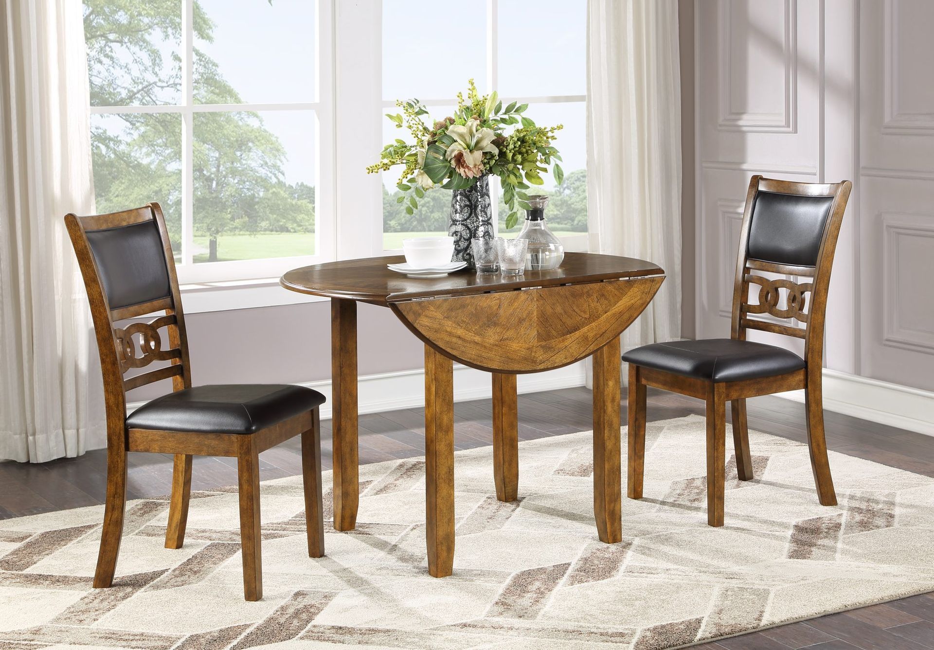 Dining table set with two dark wood chairs, glass vase of flowers, in a bright living room