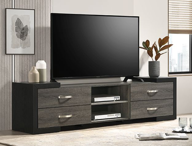 Modern black TV stand with flat-screen TV, drawers, shelves, and decor in a bright living room